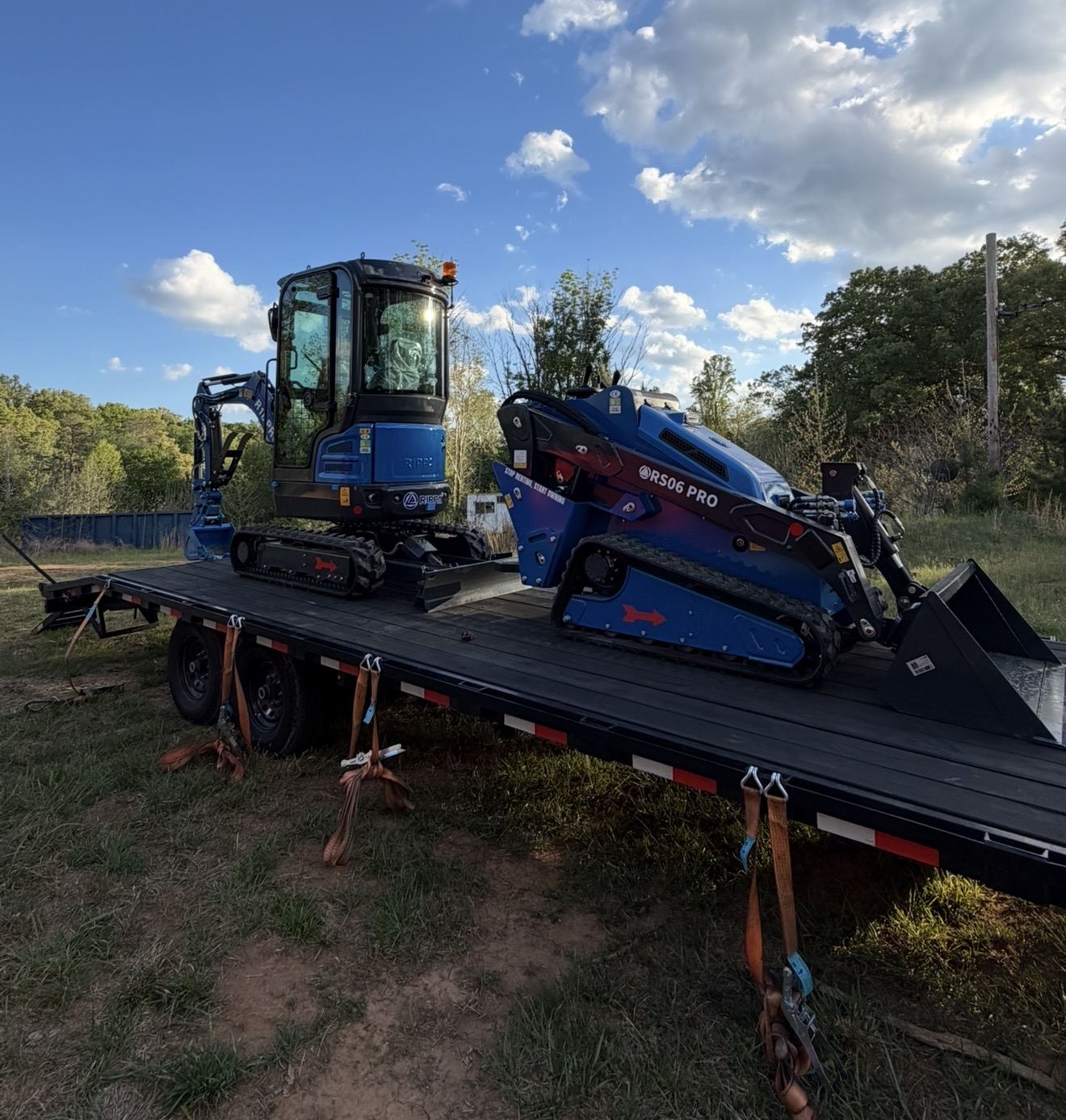 Lineup of RS06 Pro skid steers and a cab excavator